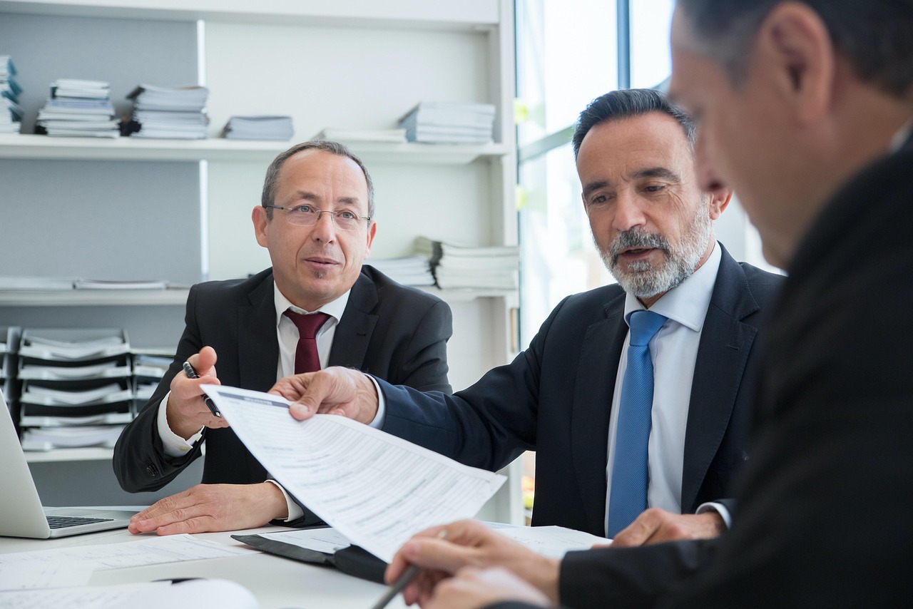 Professional business consultation with sellers reviewing documents